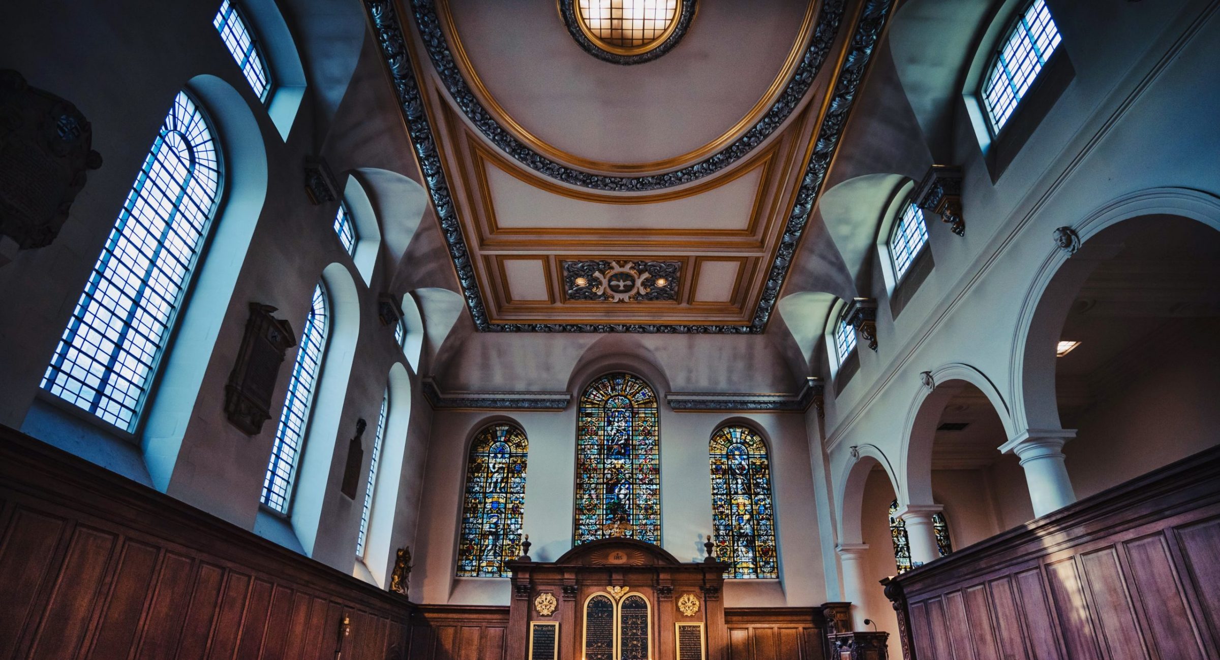 The interior of St Vedast, with its arched windows and ornate ceiling.